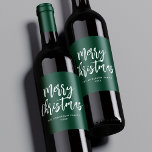Green and White Brush Script Merry Christmas Wine Label<br><div class="desc">Festive holiday wine labels featuring "Merry Christmas" displayed in white brush script lettering with a green background. Personalize the Merry Christmas wine labels with your family name and the year displayed in white lettering.</div>