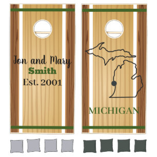 Green and wood-look backyard yard game. cornhole set