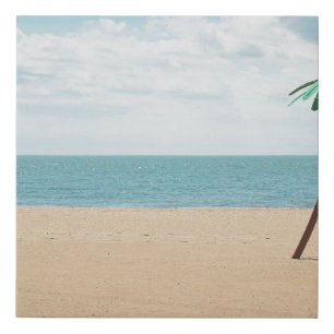 Green artificial palm tree on seashore faux canvas print