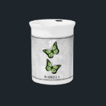 Green Butterfly Floral Beverage Pitcher<br><div class="desc">Serve your hot or cold beverages with this unique Green Butterfly Floral Personalized Porcelain Pitcher. Pitcher design features a pair of vibrant butterflies resting on a white floral vine against a light gray grunge background. Additional gift items available with this design as well as a variety of colors.</div>