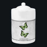 Green Butterfly Floral Teapot<br><div class="desc">Enjoy your tea with a Green Butterfly Floral Personalized Teapot.  Teapot design features a pair of vibrant butterflies resting on a white floral vine against a light gray grunge background. Additional gift items available with this design as well as a variety of colors.</div>