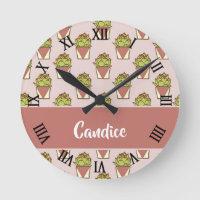 Green cactus plants on pink round clock