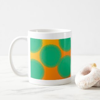 green circle in yellowish orange coffee mug