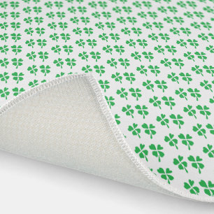 Green clover leaves pattern on white outdoor rug