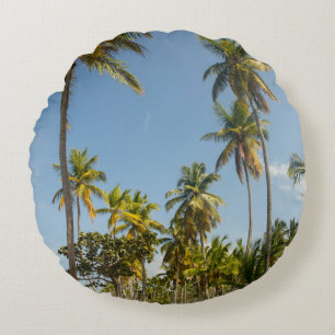 Green coconut palm tree near green grass field in  round pillow