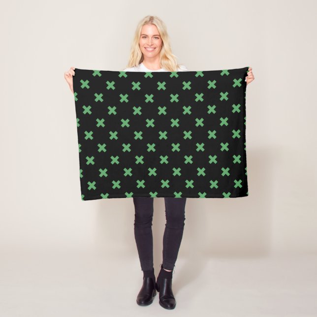 Green cross stitches on black fleece blanket (In Situ)
