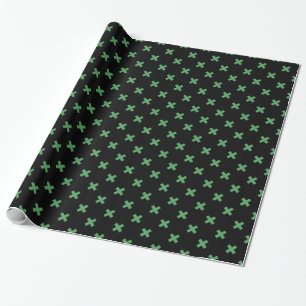 Green cross stitches on black wrapping paper