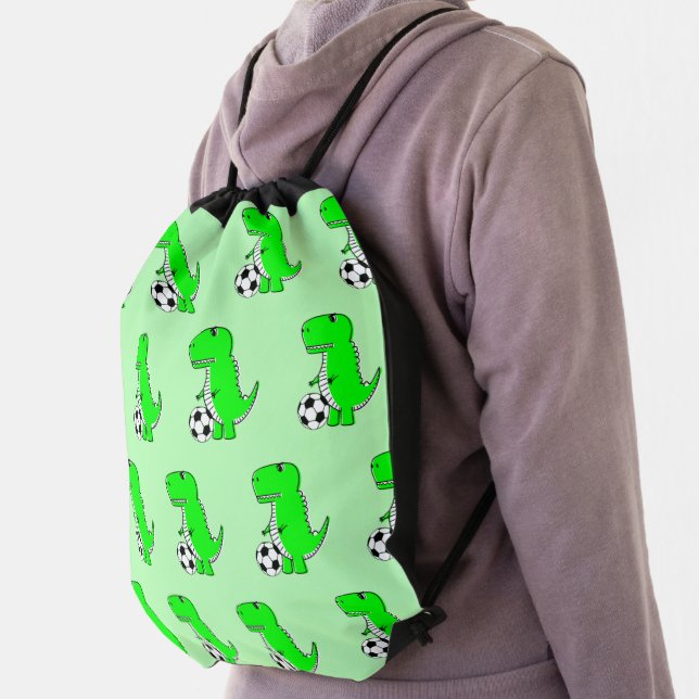 Green Dinosaur Loves Soccer Cartoon Pattern Drawstring Bag (Insitu)