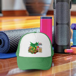 Green Dragon Pastry Chef Trucker Hat<br><div class="desc">A small green dragon sits on a wooden cutting board in a kitchen counter top. Baked goods such as muffins,  cookies and cupcakes are all around the green kitchen dragon in a backdrop of purple.</div>