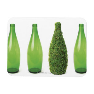 Green glass bottles showing recycling and magnet