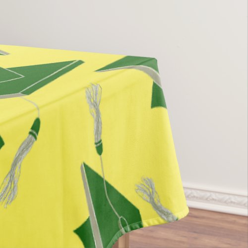 Green Graduation Caps Tossed in the Air on Yellow Tablecloth