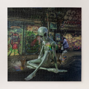 GREEN GREY ALIEN SITTING ON PAVEMENT WITH GRAFFITI JIGSAW PUZZLE