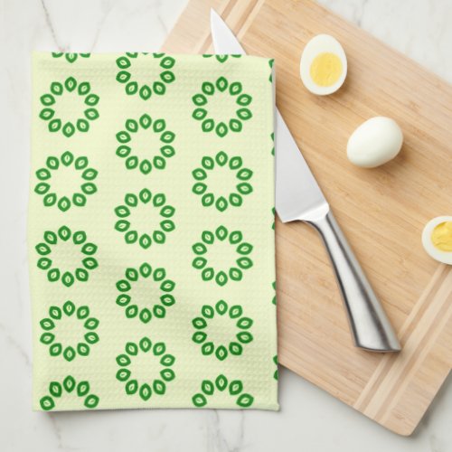 Green leaves in a circle on yellow  kitchen towel