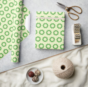 Green leaves in a circle on yellow wrapping paper