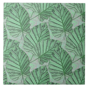 Green leaves on a gray stone. ceramic tile