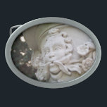 Green Man Oval Belt Buckle<br><div class="desc">The face with vines and flowers protruding from his mouth is known as a Green Man. In this color photograph, the high relief sculpture is an architectural element that is part of a large planter atop a column. Shallow depth of field highlights the sculpture. Bokeh, out of focus circles of...</div>