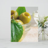 Green marinated olives pitted in a glass cup (Standing Front)