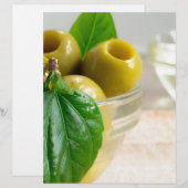 Green marinated olives pitted in a glass cup (Front/Back)
