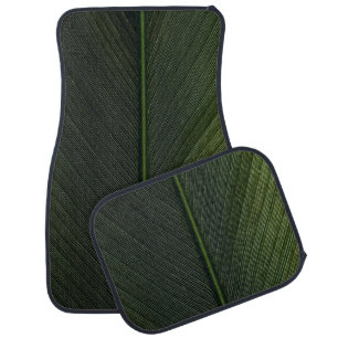 Green metal rod on black and white pinstripe texti car floor mat