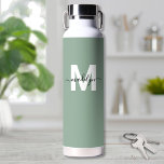 Green Modern Name Monogram Water Bottle<br><div class="desc">Create Your Own Personalized Sage Green Name Monogram Water Bottle. This cute and stylish water bottle features a soft sage green background for an earthy, calming vibe. A bold white initial sits in the center, overlaid by a flowing black script name for a personalized touch on both sides. Ideal for...</div>