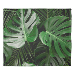 Green monstera leaves and palm leaves duvet cover
