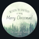 Green Mountain Pines Festive Merry Christmas Classic Round Sticker<br><div class="desc">These fun stickers are perfect as envelope seals or gift tags. They feature a rustic watercolor design of green pine trees shrouded in mist or fog. The caption reads: "wishing you and yours a very Merry Christmas!" There is space for your name and the year below.</div>