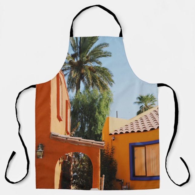 Green palm tree beside brown concrete building in  apron (Front)