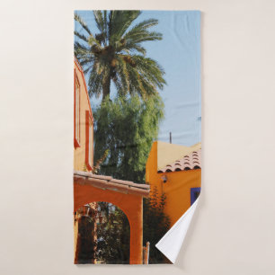 Green palm tree beside brown concrete building in  bath towel