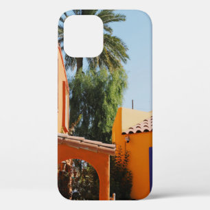 Green palm tree beside brown concrete building in iPhone 12 case
