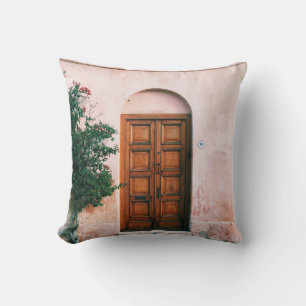 GREEN PLANTS BESIDE BROWN WOODEN DOOR THROW PILLOW