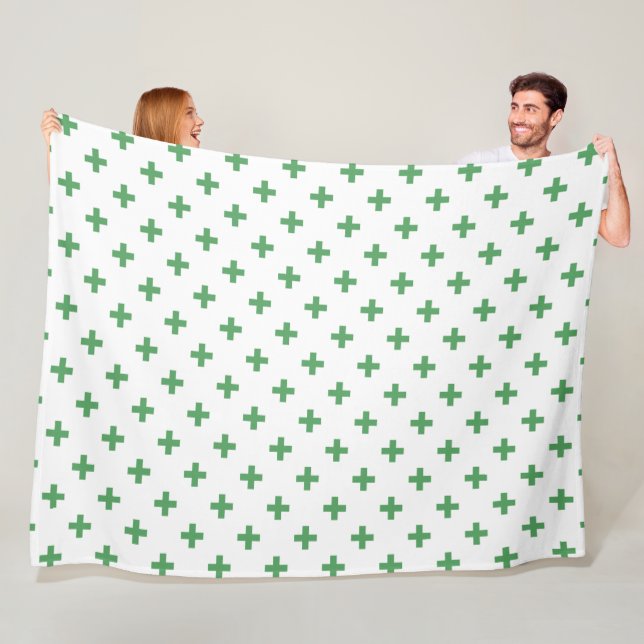 Green polka crosses on white fleece blanket (In Situ)