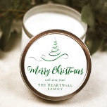 Green Silver Ribbon Tree Merry Christmas Script Classic Round Sticker<br><div class="desc">This modern holiday sticker features a green and silver faux foil ribbon Christmas tree sprinkled with silver faux glitter,  and the words "Merry Christmas" in stylish green calligraphy script. Personalize it with your family's name in serif font.</div>