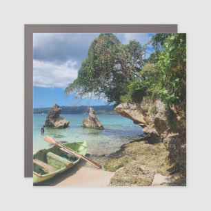 Green wooden fishing boat on a white sand car magnet