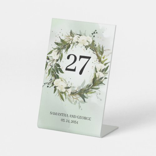 Greenery olive foliage white roses table number pedestal sign