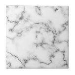 Grey and white Marble effect tile<br><div class="desc">This tile features a refined white marble design highlighted by soft gray veining. The natural marble pattern offers subtle detail and a clean, classic look that enhances both modern and traditional spaces. With a smooth, glossy finish, the tile is durable and easy to maintain—making it suitable for kitchen backsplashes, bathroom...</div>