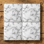 Grey and white Marble effect tile<br><div class="desc">This tile features a refined white marble design highlighted by soft gray veining. The natural marble pattern offers subtle detail and a clean, classic look that enhances both modern and traditional spaces. With a smooth, glossy finish, the tile is durable and easy to maintain—making it suitable for kitchen backsplashes, bathroom...</div>