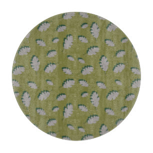 Grey autumn leaves pattern on a green background cutting board
