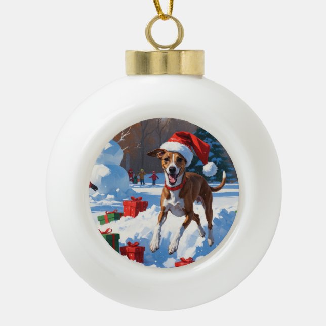 Greyhound Running in Snow with Christmas Hat Ceramic Ball Christmas Ornament (Front)
