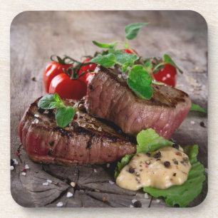 Grilled bbq steaks with fresh herbs and tomatoes coaster
