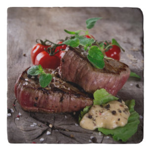 Grilled bbq steaks with fresh herbs and tomatoes trivet
