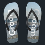 Groom Ocean Waves Beach Sand Flip Flops<br><div class="desc">Pretty Blue Sky with Light Fluffy White Clouds, Blue Sea, Crashing Ocean Waves and Beach Sand. Unisex Flip Flops with Groom and Date of Marriage written in a white color text. PERSONALIZE with your Wedding DATE (or delete text). The wedding date is written in the sand. Shown with Wide Black...</div>