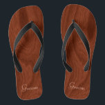Groom Wedding Day Rustic Wood Look Beach Honeymoon Flip Flops<br><div class="desc">Rustic wood look groom thong sandals flip flops perfect for beach weddings- Reads Groom in elegant, pastel lettering at the bottom. Elegant, rich mahogany woodgrain pattern look background. Note: Wood is printed image. Rustic wedding favors for bridal party members. Just change text templates to create your own personalized wedding party...</div>