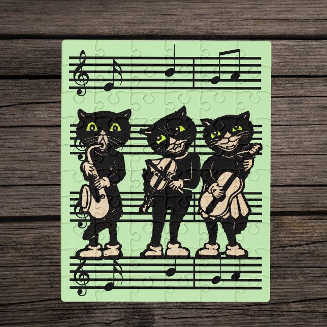 Group Black Cat Musicians Playing Instruments Jigsaw Puzzle (Three black cats playing musical instruments on sheet of music on light green jigsaw puzzle.)