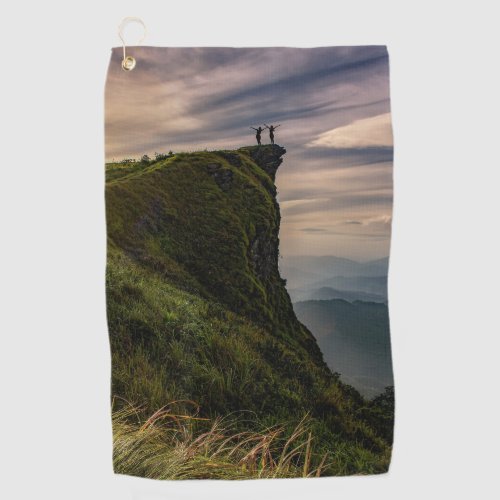 Group of people standing on a cliff edge Towels