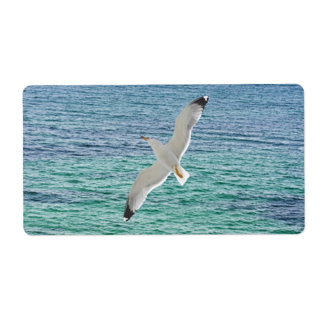 Gull flying above a sea label (Front)