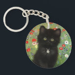 Gustav Klimt Kitten Keychain<br><div class="desc">Keychain featuring a Gustav Klimt kitten! This black kitty wears a silver collar and sits in a field of red,  blue,  white,  and yellow flowers. A wonderful gift for cat lovers and Austrian art enthusiasts!</div>