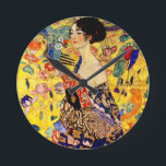 Gustav Klimt Lady with Fan Round Clock<br><div class="desc">Clock featuring Gustav Klimt’s oil painting Lady with Fan (1918). A woman wearing a blue kimono holds a red fan against a colorful yellow background of flowers and peacocks. A great gift for fans of Japonisme and European art.</div>