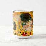 Gustav Klimt The Kiss Coffee Mug<br><div class="desc">Coffee Mug featuring Gustav Klimt’s oil painting with gold leaf The Kiss (1908). A man and woman,  wearing brilliant golden colors,  lovingly embrace and kiss in a field of flowers. A great gift for fans of Art Nouveau and Austrian art.</div>
