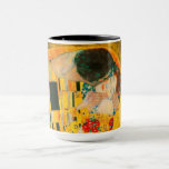 Gustav Klimt The Kiss Mug<br><div class="desc">Coffee Mug featuring Gustav Klimt’s oil painting with gold leaf The Kiss (1908). A man and woman,  wearing brilliant golden colors,  lovingly embrace and kiss in a field of flowers. A great gift for fans of Art Nouveau and Austrian art.</div>