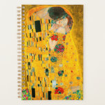 Gustav Klimt The Kiss Planner<br><div class="desc">Planner featuring Gustav Klimt’s oil painting with gold leaf The Kiss (1908). A man and woman,  wearing brilliant golden colors,  lovingly embrace and kiss in a field of flowers. A great gift for fans of Art Nouveau and Austrian art.</div>